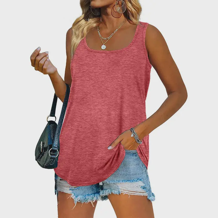 Woman wearing a red tank top and denim shorts with a black handbag on a white background