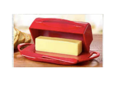 Red butter dish with a stick of butter on a wooden surface