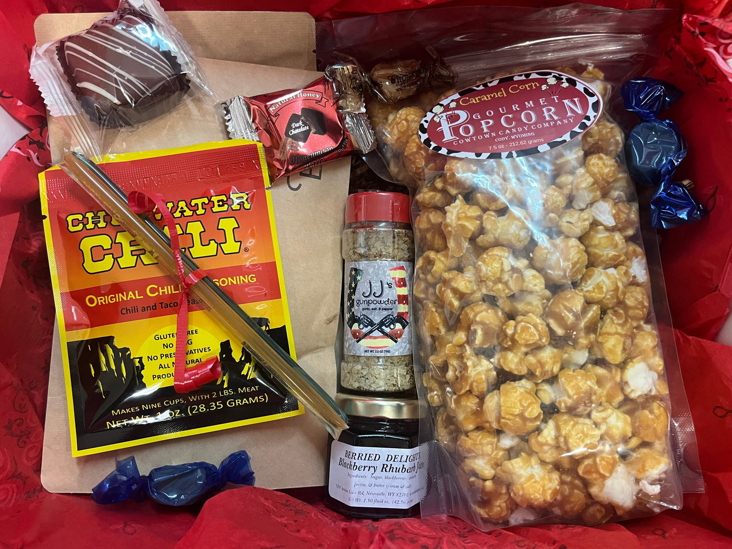 Gourmet popcorn with seasonings and candy on a red background