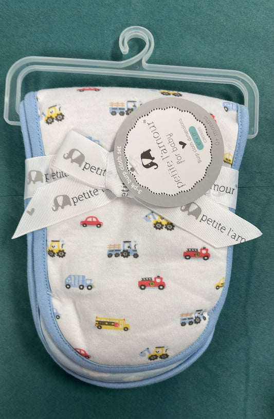 Baby bib set with vehicle pattern on a hanger against a teal background