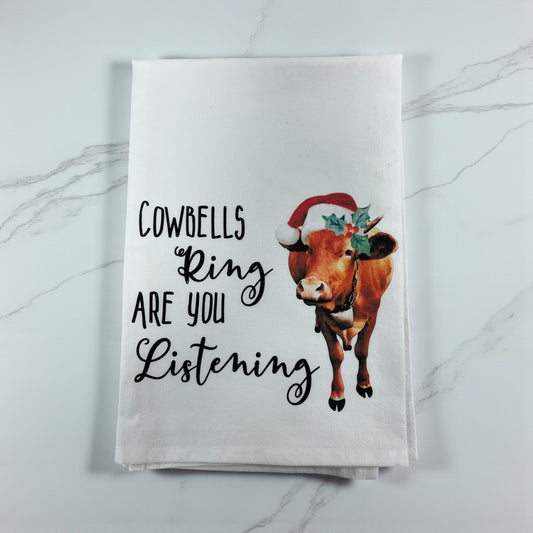 Towel with a cow illustration and text on a marble surface