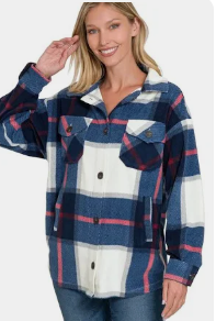 Woman wearing a plaid shirt with blue, red, and white pattern on a white background