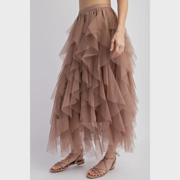 Brown tiered tulle skirt worn by a person on a light gray background