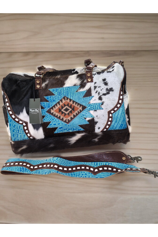 A luxurious turquoise leather and real hide duffel bag with a geometric pattern, showcasing a bag and two different straps.