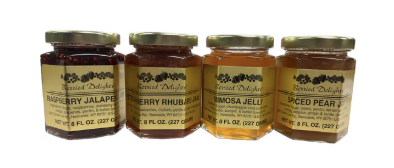 Four jars of different types of jelly with labels on a white background