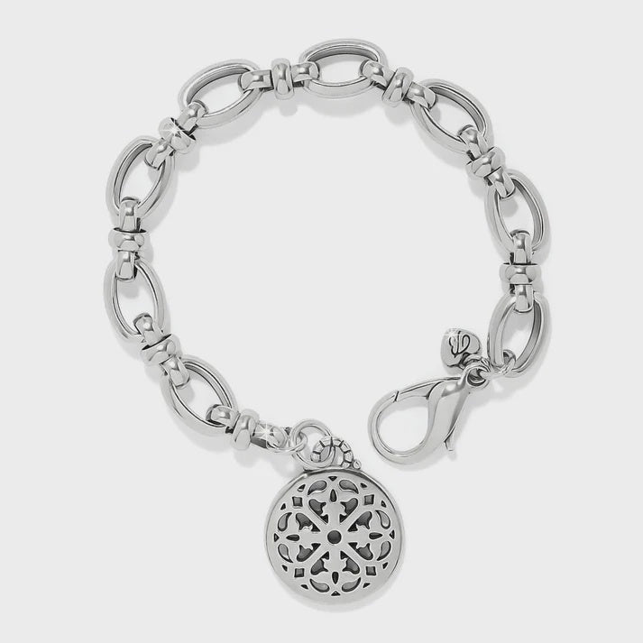 Silver bracelet with a decorative charm on a white background