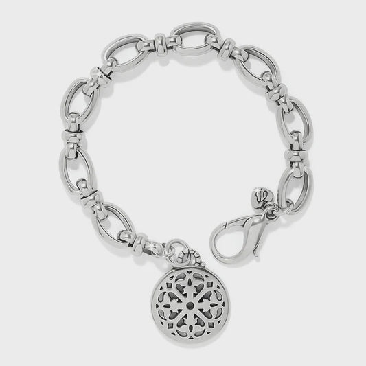 Silver bracelet with a decorative charm on a white background