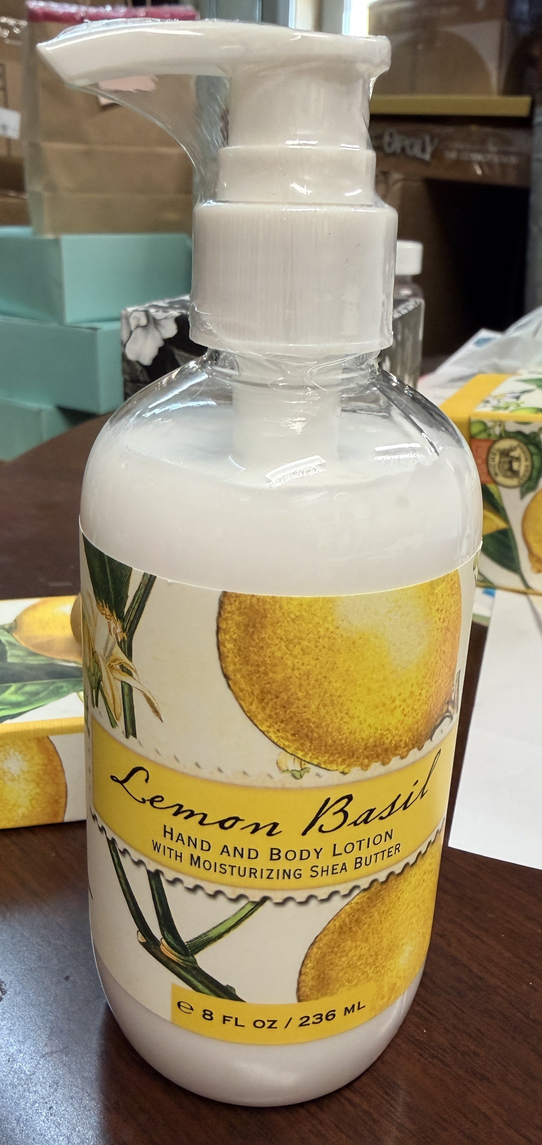 Lemon Basil hand and body lotion bottle on a wooden surface
