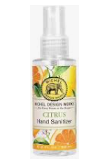 A spray bottle of Michel Design Hand Sanitizer with a citrus design, featuring orange and green colors and an elephant logo.